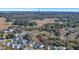 An aerial view showcases a charming home nestled within a lush, tree-filled neighborhood at 2028 Ironstone Aly, Charleston, SC 29407
