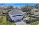 Aerial view showcasing the home's three-car garage, backyard, and surrounding trees at 2028 Ironstone Aly, Charleston, SC 29407