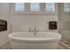 Elegant soaking tub with modern fixtures and bright natural light at 2028 Ironstone Aly, Charleston, SC 29407