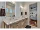 Bathroom featuring double vanity with wooden cabinets, white countertop and decorative mirrors at 2028 Ironstone Aly, Charleston, SC 29407