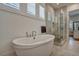 Elegant soaking tub and glass shower with bright natural light at 2028 Ironstone Aly, Charleston, SC 29407
