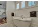 Elegant soaking tub with modern fixtures and bright natural light at 2028 Ironstone Aly, Charleston, SC 29407