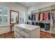 Organized walk-in closet with custom shelving, drawers and large island at 2028 Ironstone Aly, Charleston, SC 29407
