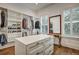 Spacious walk-in closet with custom shelving, drawers and central island at 2028 Ironstone Aly, Charleston, SC 29407
