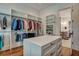 Large walk-in closet with custom shelving, drawers, and central island at 2028 Ironstone Aly, Charleston, SC 29407