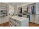 Spacious walk-in closet with custom shelving, drawers, and central island at 2028 Ironstone Aly, Charleston, SC 29407