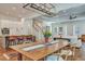 Open-concept dining area showcases the dark wood table, flowing into the kitchen with barstool seating at 2028 Ironstone Aly, Charleston, SC 29407