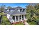 Charming home featuring a welcoming front porch, black shutters, and beautifully landscaped yard at 2028 Ironstone Aly, Charleston, SC 29407
