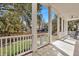 Inviting porch with white railings, columns, and a well-maintained green lawn at 2028 Ironstone Aly, Charleston, SC 29407