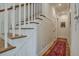 Elegant foyer featuring hardwood floors, paneled walls, and a staircase with wood treads at 2028 Ironstone Aly, Charleston, SC 29407