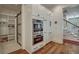 Modern kitchen with built-in oven, pantry storage, and hardwood floors leading to the staircase at 2028 Ironstone Aly, Charleston, SC 29407
