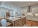 Gourmet kitchen area with a central island, seamlessly connecting to the dining area with rustic table and chairs at 2028 Ironstone Aly, Charleston, SC 29407