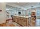 Open concept kitchen connects to the living room, featuring an island and hardwood floors throughout the space at 2028 Ironstone Aly, Charleston, SC 29407