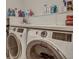Modern laundry room featuring front-load washer and dryer and generous shelf space for supplies at 2028 Ironstone Aly, Charleston, SC 29407