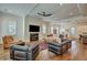 Spacious living room with a fireplace, large TV, and elegant decor at 2028 Ironstone Aly, Charleston, SC 29407