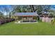 Outdoor wooden gazebo with benches and tables in a spacious, green backyard, surrounded by brick walls at 2028 Ironstone Aly, Charleston, SC 29407