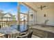 Covered patio with ceiling fan, table and chairs, plus neighborhood views, providing a delightful outdoor dining and relaxation area at 2028 Ironstone Aly, Charleston, SC 29407