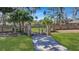 Gated property entrance with a paved driveway, brick pillars, and lush greenery at 2028 Ironstone Aly, Charleston, SC 29407