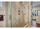 Luxurious walk-in shower with glass enclosure and pebble tile flooring at 2028 Ironstone Aly, Charleston, SC 29407