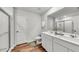 Bright bathroom featuring a double vanity, large mirror, and glass-enclosed shower at 215 W Bradford Pointe Drive Dr, Summerville, SC 29483