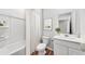 Neat bathroom with a shower-tub combo, white cabinets, and a large mirror at 215 W Bradford Pointe Drive Dr, Summerville, SC 29483