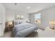Bright bedroom features cozy bedding, bedside lamps, and a window with a view at 215 W Bradford Pointe Drive Dr, Summerville, SC 29483