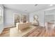 Bright home office featuring hardwood floors, a modern desk, and built-in shelving with decor at 215 W Bradford Pointe Drive Dr, Summerville, SC 29483