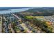 Aerial view showing the neighborhood, surrounding trees, pond, and the waterway at 221 Waning Way, Charleston, SC 29492