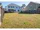 Fenced backyard provides a spacious lawn, covered porch and room to play at 221 Waning Way, Charleston, SC 29492