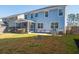 Spacious backyard with a screened porch, stone patio, and lush green grass at 221 Waning Way, Charleston, SC 29492