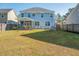 Large backyard featuring a covered porch, stone patio, lawn, and fenced perimeter at 221 Waning Way, Charleston, SC 29492