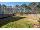 Spacious backyard with mature trees, lawn, and volleyball net, perfect for outdoor activities at 221 Waning Way, Charleston, SC 29492