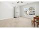 Bright bedroom with neutral carpet, ceiling fan, and a large window with neighborhood view at 221 Waning Way, Charleston, SC 29492