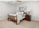 Bedroom features a wooden bed frame, beige carpet, and decorative wall letters at 221 Waning Way, Charleston, SC 29492