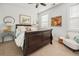 Cozy bedroom with a dark wood bed frame, comfortable armchair, and bright, natural lighting at 221 Waning Way, Charleston, SC 29492