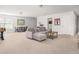 Spacious bonus room with a lounge area, foosball table, and dining set provides versatile living space at 221 Waning Way, Charleston, SC 29492