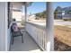 Cozy covered front porch with a chair and decorative pillows and a nice view at 221 Waning Way, Charleston, SC 29492