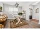 Well-lit home office with a white desk, stylish decor, and a view towards the front door at 221 Waning Way, Charleston, SC 29492