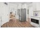 Bright kitchen showcasing stainless steel refrigerator and view to adjacent dining area at 221 Waning Way, Charleston, SC 29492