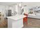 Modern kitchen featuring island with bar seating, stainless steel appliances, and open living space at 221 Waning Way, Charleston, SC 29492