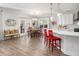 Open-concept kitchen and dining area with stainless steel appliances and modern finishes at 221 Waning Way, Charleston, SC 29492