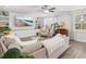 Spacious living room with a large sectional, built-in shelving, hardwood floors and natural light at 221 Waning Way, Charleston, SC 29492