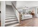 Open floor plan showcases staircase flowing into the living room with sectional sofa and built-ins at 221 Waning Way, Charleston, SC 29492