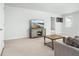 Bright living room features a TV, neutral carpet, and access to other rooms at 221 Waning Way, Charleston, SC 29492