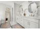 Main bathroom with double vanity, marble countertops, and stylish mirrors provides a luxurious feel at 221 Waning Way, Charleston, SC 29492