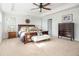 Sun-filled main bedroom with a tray ceiling and wooden furniture adds warmth to this comfortable retreat at 221 Waning Way, Charleston, SC 29492