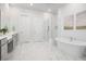 Bright bathroom with dual vanity, glass shower, soaking tub, white subway tile, and marbled floors at 2305 Sturgeon, Johns Island, SC 29455