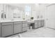 Bathroom boasts double vanity, a makeup table, and pristine white countertops, all complemented by marble floors at 2305 Sturgeon, Johns Island, SC 29455