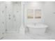 Bright bathroom featuring a glass-enclosed shower and a freestanding soaking tub with modern fixtures and neutral decor at 2305 Sturgeon, Johns Island, SC 29455