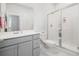 Modern bathroom with a gray vanity, a sleek frameless glass shower, and marble-like tile flooring at 2305 Sturgeon, Johns Island, SC 29455